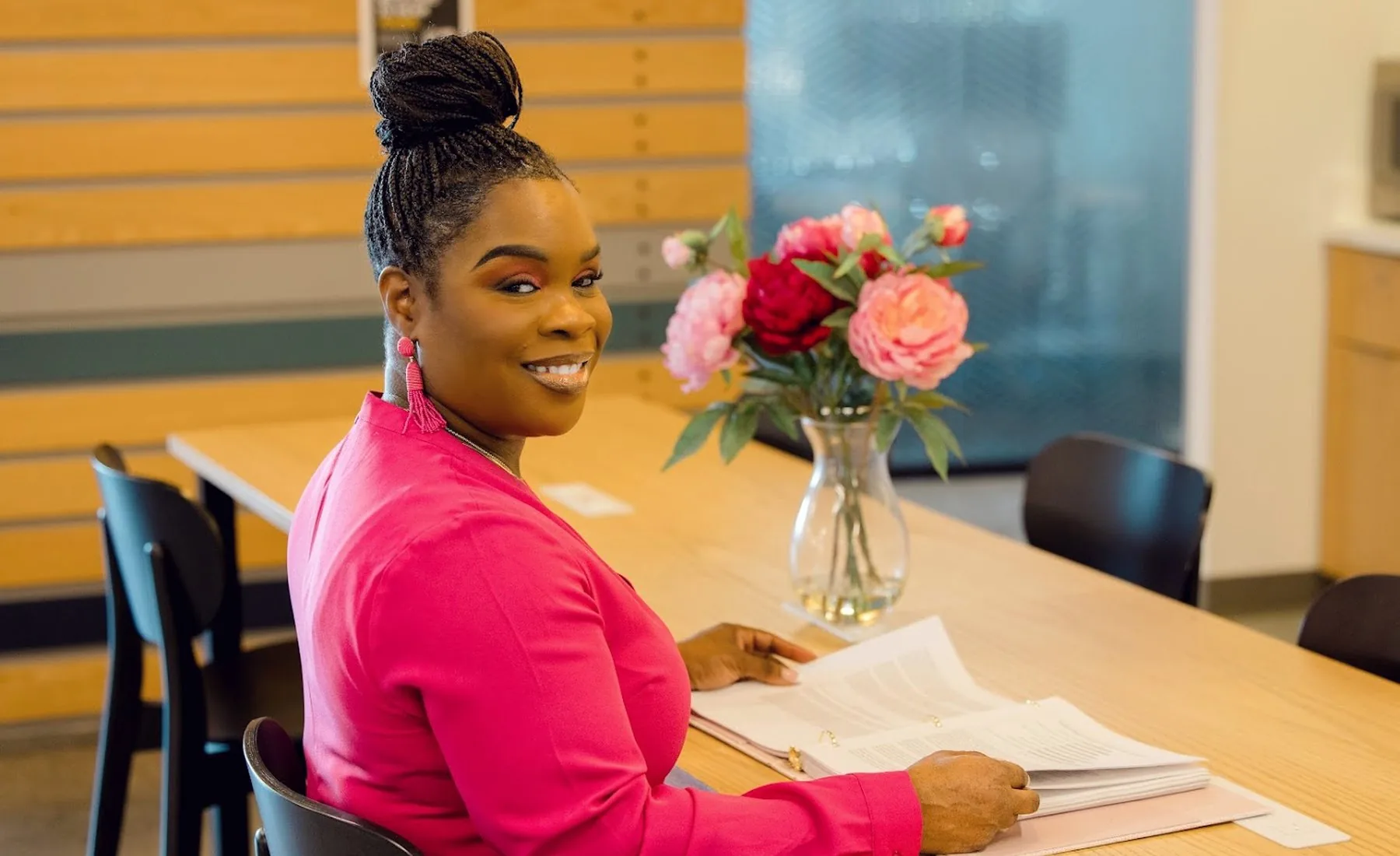 Latisha Newby in conversation across a table.